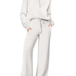 Women’s sports suit with wide-leg pants in white, featuring a zip-up top and comfortable fit for workouts and lounging.