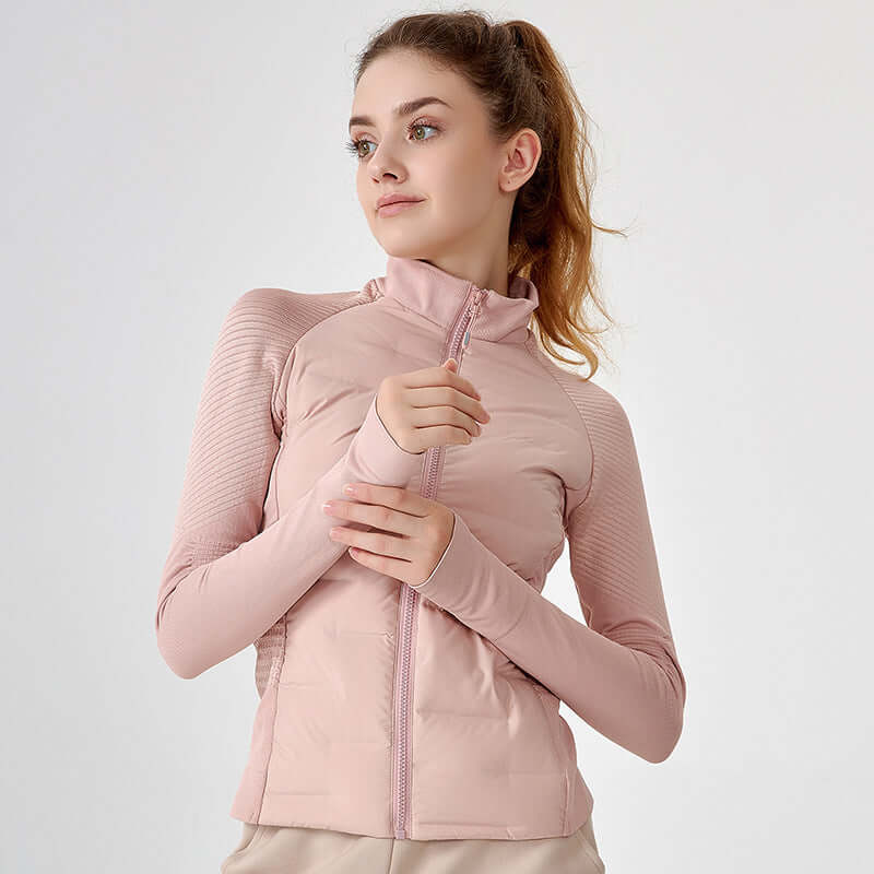 Woman wearing a pink jacket on a light gray background