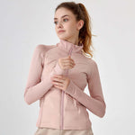 Woman wearing a pink jacket on a light gray background