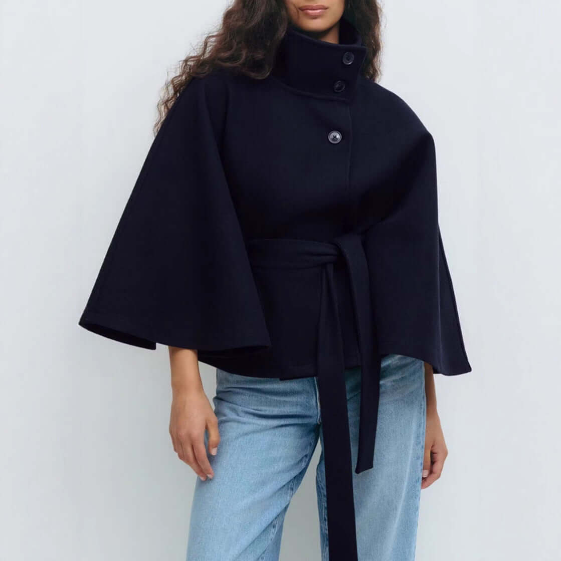 Model wearing a winter batwing sleeve coat with belt, showcasing elegant style and comfort in navy color.