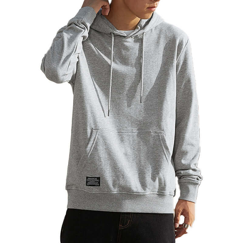 Gray hoodie worn by a person on a white background