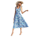 Woman wearing a blue floral dress and straw hat on a white background