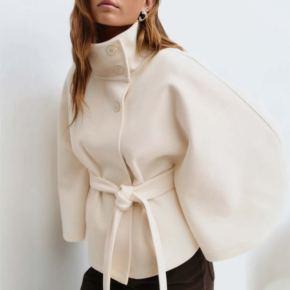 Winter batwing sleeve coat in cream with high neck and belted waist, perfect for elegant winter styling.