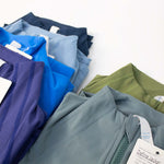 Colorful display of womens lightweight standing collar jackets in various shades arranged neatly.