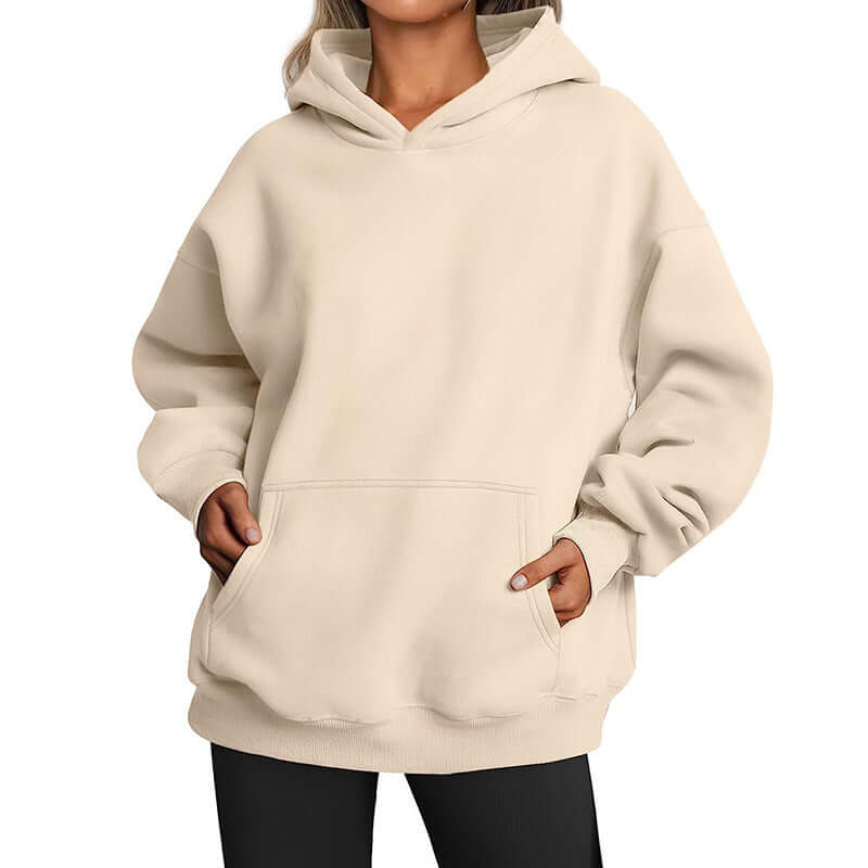 Beige hoodie worn by a person on a white background