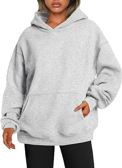 Gray hoodie worn by a person on a white background