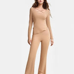 Solid color pajama set featuring a comfortable top and pants in a neutral shade, ideal for lounging or casual wear.