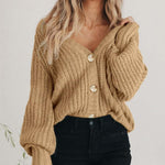 Women’s thick knitted cardigan sweater in beige with buttons and long sleeves, ideal for cold weather.