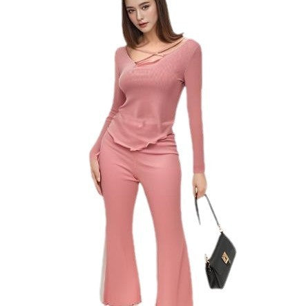 Solid color pajama set in pink featuring a comfortable top and pants for lounging or casual wear.
