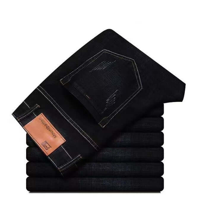 Stack of black jeans with a visible brand label on a white background