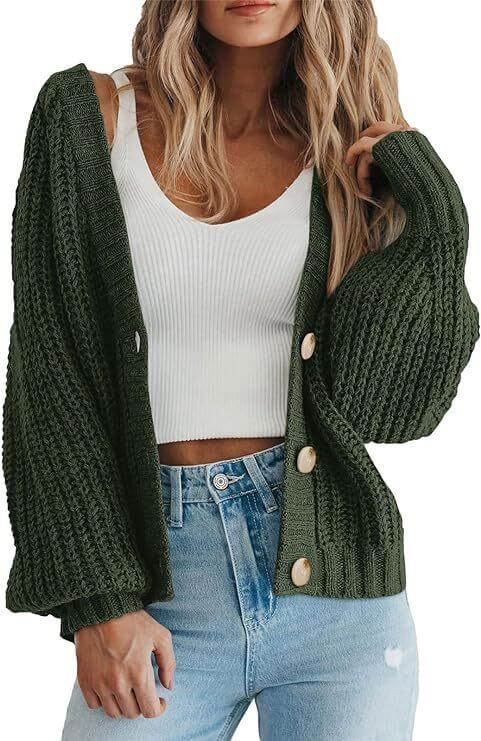 Women’s thick knitted cardigan sweater in green, warm button-down style over a white top and jeans by VexoFinds.